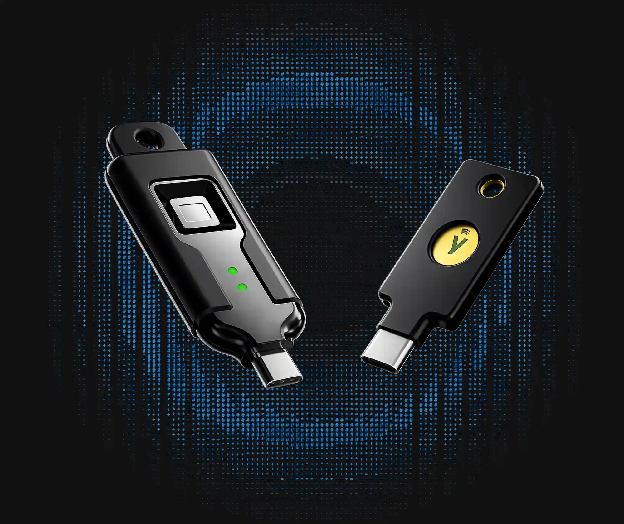 Token BioStick with fingerprint sensor beside a YubiKey security key