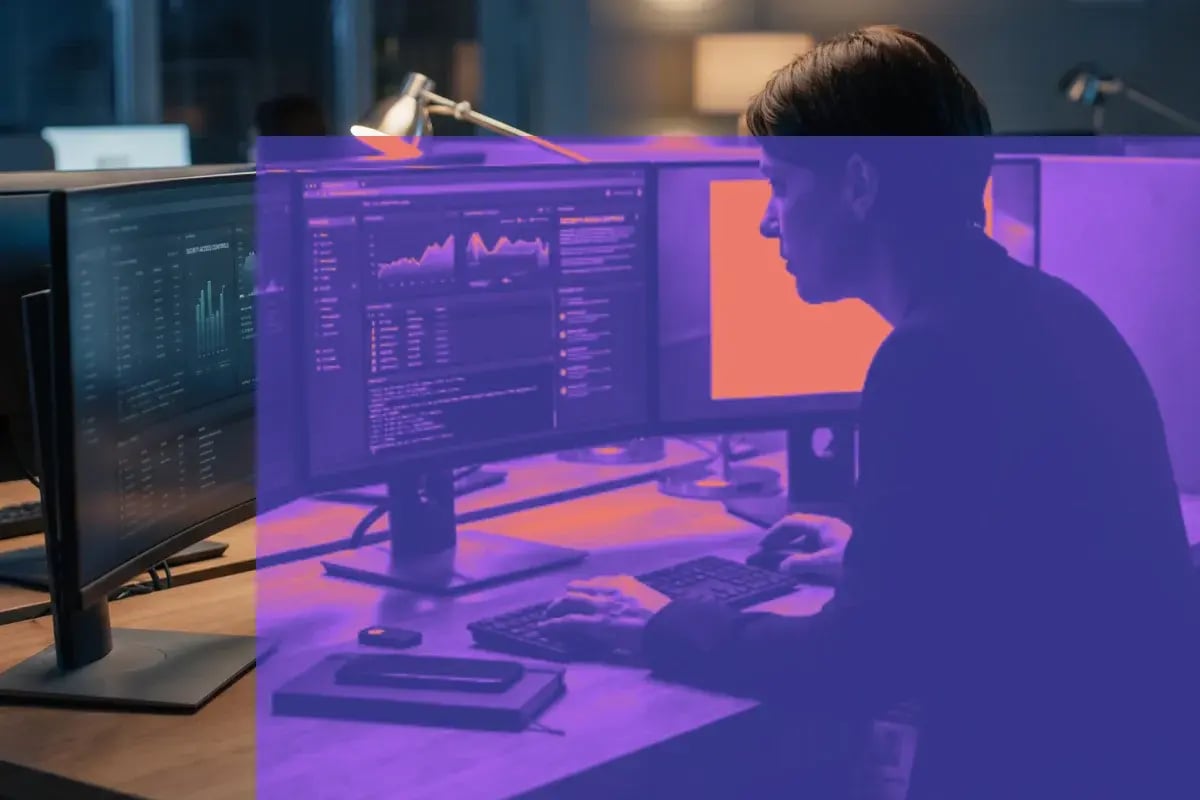 Systems administrator working at a multi-monitor console